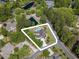 Beautiful aerial view highlighting lush and private backyard with in-ground pool, pond and wooded surround at 12 Gloucester Pl., Pawleys Island, SC 29585