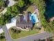 Aerial shot of backyard pool area, outdoor seating, lush landscaping and white fencing at 12 Gloucester Pl., Pawleys Island, SC 29585