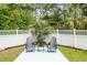 Cozy backyard seating area with two chairs, a small table, and a well-maintained garden at 12 Gloucester Pl., Pawleys Island, SC 29585