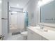 Bright bathroom featuring a shower-tub combination, decorative surfboard, and neutral color palette at 12 Gloucester Pl., Pawleys Island, SC 29585