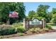 Welcome to Ricefields; a beautiful brick community sign with mature landscaping and American flag at 12 Gloucester Pl., Pawleys Island, SC 29585