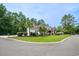 Charming curb appeal with lush lawn, mature trees, and a mix of brick and siding on this two story home at 12 Gloucester Pl., Pawleys Island, SC 29585