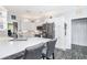 Modern kitchen with white cabinets, stainless steel appliances, and a breakfast bar with seating at 12 Gloucester Pl., Pawleys Island, SC 29585