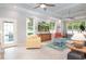 Open concept room with tile floors, neutral paint colors, and large windows overlooking the pool at 12 Gloucester Pl., Pawleys Island, SC 29585