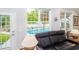 Cozy living room area with views of the pool visible from the windows at 12 Gloucester Pl., Pawleys Island, SC 29585