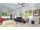 Bright living space with tile floors, recessed lighting, ceiling fans, and multiple windows at 12 Gloucester Pl., Pawleys Island, SC 29585