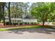 Exterior shot of a well-maintained pool house with lush landscaping at 12 Gloucester Pl., Pawleys Island, SC 29585