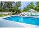 Beautiful backyard pool with ample seating, landscaped surroundings, and privacy fence at 12 Gloucester Pl., Pawleys Island, SC 29585