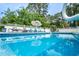 Inviting outdoor pool area with lounge chairs and manicured landscaping perfect for relaxation and entertainment at 12 Gloucester Pl., Pawleys Island, SC 29585