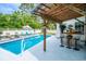 Gorgeous in-ground pool with bar, sun loungers, shade, and mature landscape at 12 Gloucester Pl., Pawleys Island, SC 29585