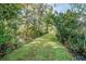 Picturesque walking trail surrounded by trees and lush greenery at 12 Gloucester Pl., Pawleys Island, SC 29585