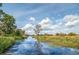 Scenic waterway view with lush vegetation and a clear, blue sky at 12 Gloucester Pl., Pawleys Island, SC 29585