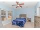 Comfortable bedroom featuring a queen-sized bed, ceiling fan, and natural light from the large window at 139 Chenoa Dr. # D, Murrells Inlet, SC 29576