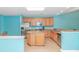 Bright kitchen boasts stainless steel appliances, wood cabinets, an island, and light tile floors at 139 Chenoa Dr. # D, Murrells Inlet, SC 29576