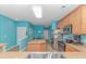 View of kitchen with island, stainless appliances, and adjacent breakfast area with window at 139 Chenoa Dr. # D, Murrells Inlet, SC 29576