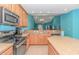 Kitchen featuring stainless steel appliances, light countertops, and an open view to the living room at 139 Chenoa Dr. # D, Murrells Inlet, SC 29576