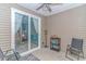Relaxing sunroom features a ceiling fan, sliding glass doors, and seating area at 139 Chenoa Dr. # D, Murrells Inlet, SC 29576