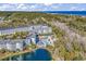 Aerial view of the multi-story condos, outdoor pool with water slides, and a tranquil lake at 14290 Ocean Hwy. # 210, Pawleys Island, SC 29585