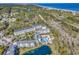 Scenic aerial view of multi-story condos, outdoor pool, and beautiful lake at 14290 Ocean Hwy. # 210, Pawleys Island, SC 29585