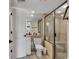 Clean bathroom with a glass-enclosed shower, tile accents, and a functional vanity with storage space at 14290 Ocean Hwy. # 210, Pawleys Island, SC 29585