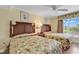 Bright bedroom featuring two beds, ceiling fan, and large window with cheerful valance and drapes at 14290 Ocean Hwy. # 210, Pawleys Island, SC 29585