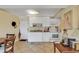 Compact kitchen with white cabinetry, standard appliances, tile flooring, and a cozy dining area nearby at 14290 Ocean Hwy. # 210, Pawleys Island, SC 29585