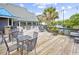 Outdoor patio with tables, chairs, and pond view, perfect for relaxing and entertaining at 14290 Ocean Hwy. # 210, Pawleys Island, SC 29585