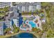 Overhead shot of a resort's pool area with slides, splash pad, lounge chairs, and lush palm trees at 14290 Ocean Hwy. # 210, Pawleys Island, SC 29585