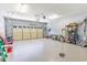 Bright garage with a mix of storage solutions and an automatic door opener and outdoor view at 1486 Medinah Ln., Murrells Inlet, SC 29576