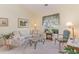 Bright living room with large windows, a floral sofa, and a cozy reading nook at 1486 Medinah Ln., Murrells Inlet, SC 29576