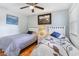 Inviting bedroom featuring two twin beds, decorative art, hardwood floors, and a ceiling fan at 1500 Cenith Dr. # F103, North Myrtle Beach, SC 29582