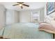 Bright bedroom with a large window, ceiling fan, and a comfortable bed featuring a light blue comforter at 1500 Cenith Dr. # F103, North Myrtle Beach, SC 29582