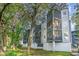Condominium building with screened in porches, grassy lawn and mature trees at 1500 Cenith Dr. # F103, North Myrtle Beach, SC 29582