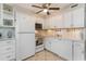 Compact kitchen with ample cabinet space and modern white appliances at 1500 Cenith Dr. # F103, North Myrtle Beach, SC 29582