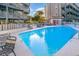 Relaxing outdoor pool with lounge chairs and well-maintained deck in a condominium complex at 1500 Cenith Dr. # F103, North Myrtle Beach, SC 29582
