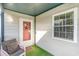 Inviting covered porch with a cozy chair, welcome mat, and decorative front door at 1500 Cenith Dr. # F103, North Myrtle Beach, SC 29582