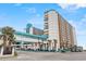 Exterior showcases resort architecture with connecting walkway, palm trees, and vibrant colors creating a captivating coastal scene at 1501 South Ocean Blvd. # 643, Myrtle Beach, SC 29577