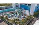 Aerial view of vibrant water park with winding slides, palm trees, and seating areas for Gathering fun at 1501 South Ocean Blvd. # 643, Myrtle Beach, SC 29577