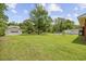 Expansive backyard featuring a large green lawn and a detached garage and shed for ample storage at 153 Busbee St., Conway, SC 29526