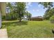 Spacious backyard featuring lush green lawn and mature trees, partially fenced in for privacy and security at 153 Busbee St., Conway, SC 29526
