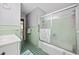 Bathroom featuring green tiles, a shower with glass doors, and a white vanity sink at 153 Busbee St., Conway, SC 29526