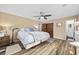 Comfortable bedroom with wood-look floors, a ceiling fan, and access to an ensuite bathroom at 153 Busbee St., Conway, SC 29526