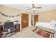 Cozy bedroom with a ceiling fan, desk, and a 