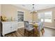 Light-filled dining room featuring stylish furnishings and a modern chandelier at 153 Busbee St., Conway, SC 29526