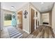 Bright foyer with new floors, coat closet, and an inviting blue front door adorned with a wreath at 153 Busbee St., Conway, SC 29526