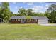 Charming brick ranch-style home with attached two-car garage, well-manicured lawn, and inviting curb appeal at 153 Busbee St., Conway, SC 29526