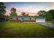 Charming brick home featuring a well-manicured lawn, a blue front door, and an attached two-car garage at 153 Busbee St., Conway, SC 29526