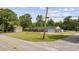 Street view of the charming brick ranch-style home with an attached garage and a large, well-maintained front yard at 153 Busbee St., Conway, SC 29526