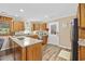 Efficient kitchen featuring an island cooktop, wooden cabinets, and stainless appliances at 153 Busbee St., Conway, SC 29526