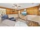 Living room featuring a flat screen TV, wood paneling, and a ceiling fan at 153 Busbee St., Conway, SC 29526